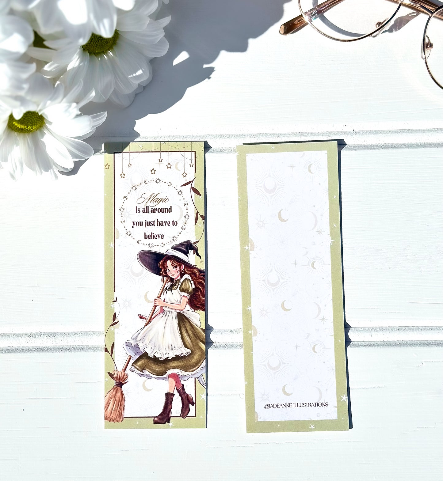 Witch-themed fantasy bookmark with a broom and flowers on a white background