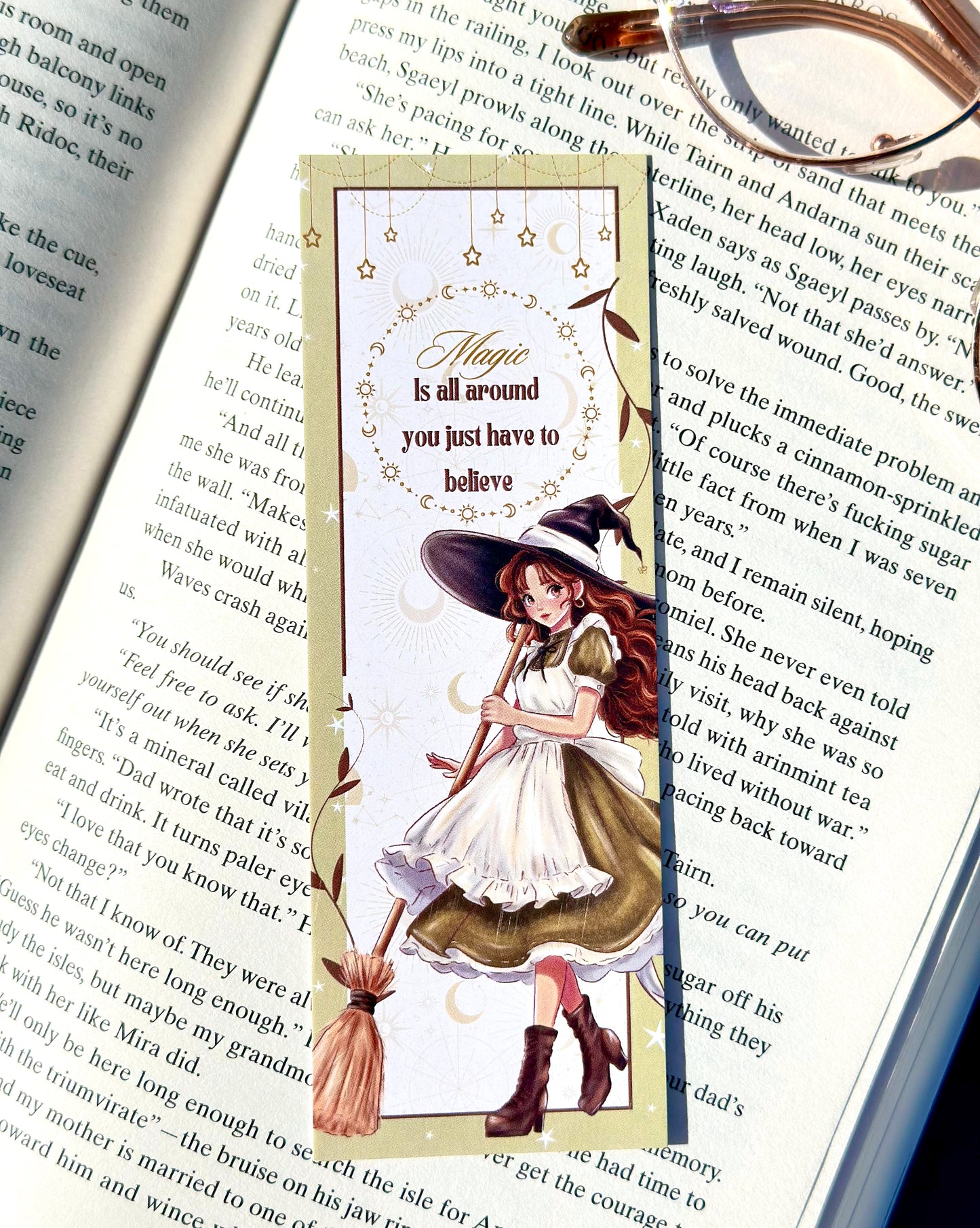 Magical-themed bookmark with a witch design on an open book.