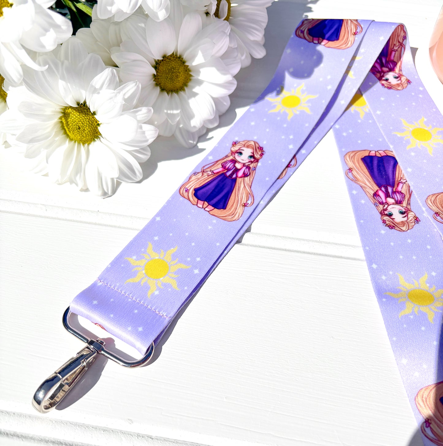 Lanyard with Cute rapunzel design on a white surface with flowers