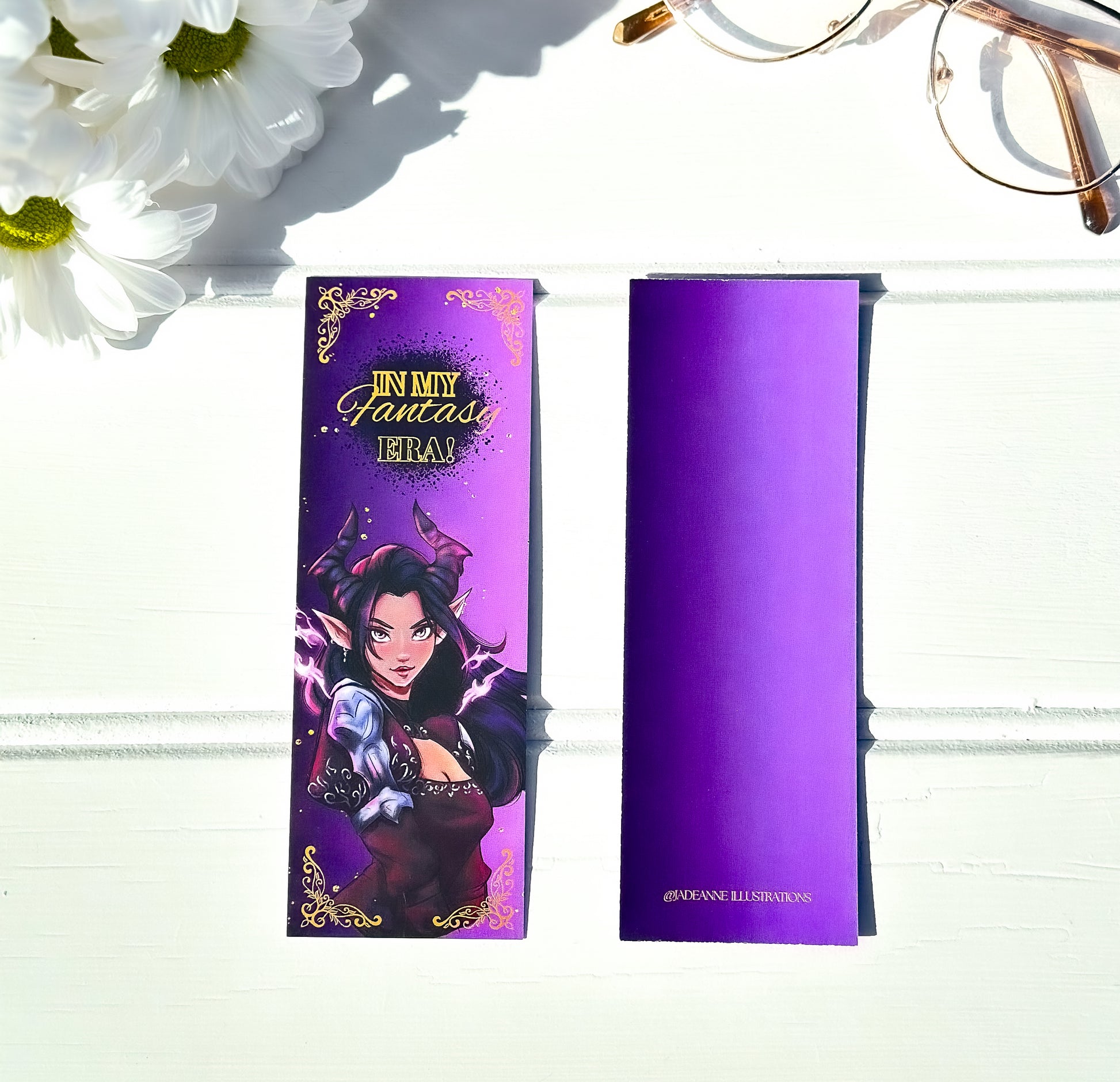 Purple bookmark with fae character illustration on a white background