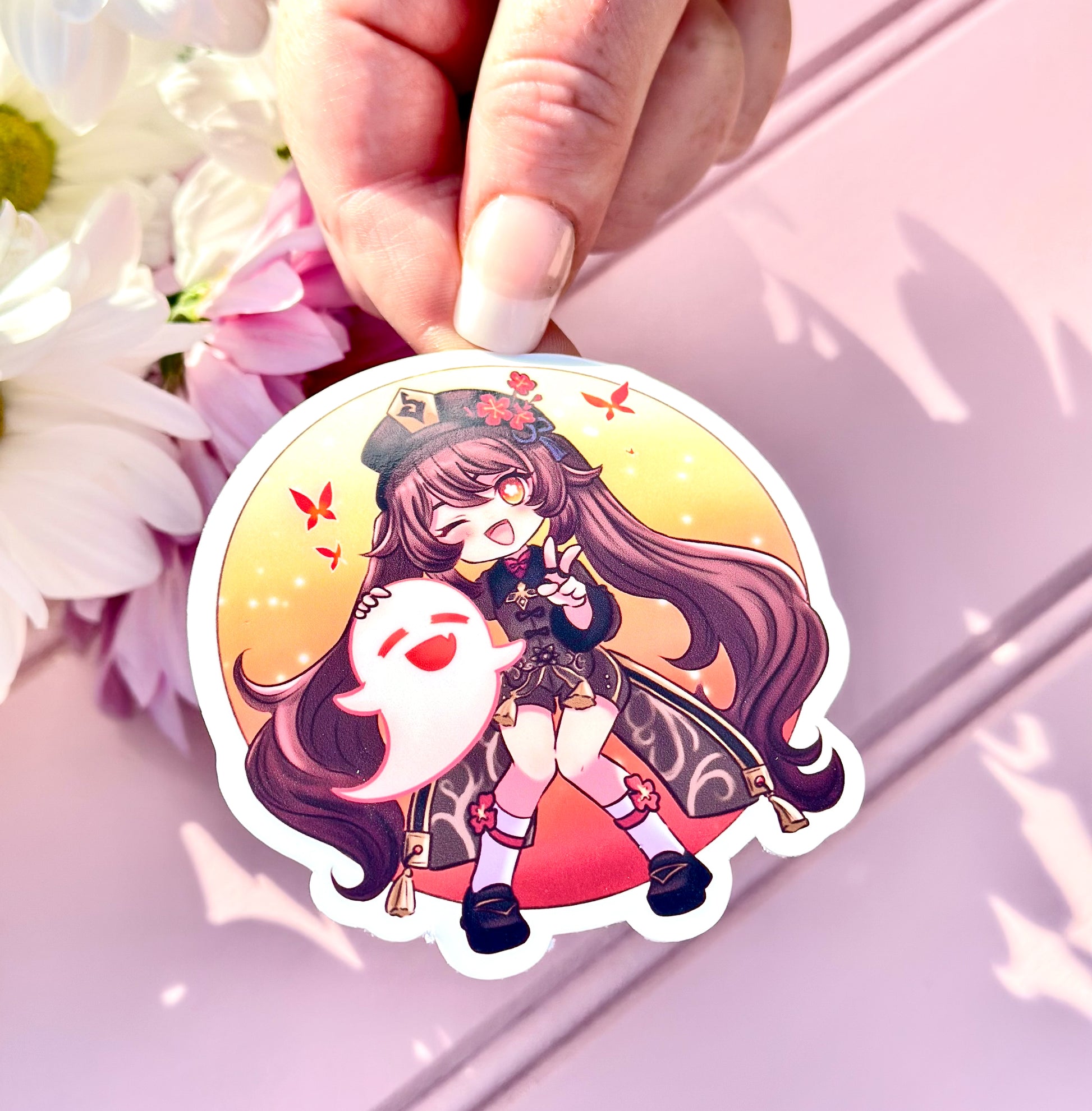 Sticker of Hu tao character held by a hand with flowers in the background